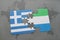 puzzle with the national flag of greece and sierra leone on a world map background.