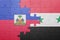 puzzle with the national flag of haiti and syria