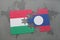 puzzle with the national flag of hungary and laos on a world map