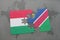puzzle with the national flag of hungary and namibia on a world map