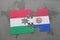 puzzle with the national flag of hungary and paraguay on a world map