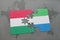 puzzle with the national flag of hungary and sierra leone on a world map