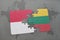 puzzle with the national flag of indonesia and lithuania on a world map background.