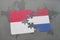 puzzle with the national flag of indonesia and netherlands on a world map background.