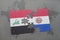 puzzle with the national flag of iraq and paraguay on a world map background.