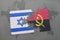 puzzle with the national flag of israel and angola on a world map background.