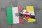puzzle with the national flag of italy and brunei on a world map background.