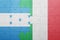 Puzzle with the national flag of italy and honduras