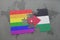 puzzle with the national flag of jordan and gay rainbow flag on a world map background.