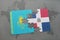 puzzle with the national flag of kazakhstan and dominican republic on a world map