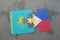 puzzle with the national flag of kazakhstan and philippines on a world map