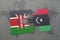 puzzle with the national flag of kenya and libya on a world map