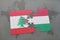 puzzle with the national flag of lebanon and hungary on a world map background.