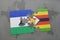 puzzle with the national flag of lesotho and zimbabwe on a world map