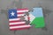 puzzle with the national flag of liberia and djibouti on a world map