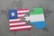 puzzle with the national flag of liberia and sierra leone on a world map