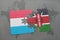 puzzle with the national flag of luxembourg and kenya on a world map