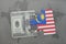 puzzle with the national flag of malaysia and dollar banknote on a world map background.