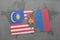 puzzle with the national flag of malaysia and mongolia on a world map background.