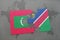 puzzle with the national flag of maldives and namibia on a world map