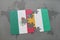 puzzle with the national flag of mexico and cote divoire on a world map background.
