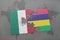 puzzle with the national flag of mexico and mauritius on a world map background.