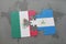puzzle with the national flag of mexico and nicaragua on a world map background.