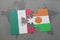 puzzle with the national flag of mexico and niger on a world map background.