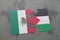 puzzle with the national flag of mexico and palestine on a world map background.