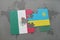 puzzle with the national flag of mexico and rwanda on a world map background.