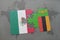 puzzle with the national flag of mexico and zambia on a world map background.