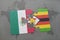 puzzle with the national flag of mexico and zimbabwe on a world map background.