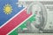 Puzzle with the national flag of namibia and dollar banknote