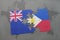 Puzzle with the national flag of new zealand and philippines on a world map background. 3D illustration