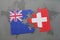 puzzle with the national flag of new zealand and switzerland on a world map background