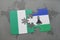 puzzle with the national flag of nigeria and lesotho on a world map