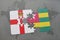 puzzle with the national flag of northern ireland and togo on a world map