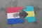 puzzle with the national flag of paraguay and bahamas on a world map background.