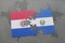 puzzle with the national flag of paraguay and el salvador on a world map background.