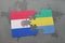 puzzle with the national flag of paraguay and gabon on a world map