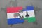 puzzle with the national flag of paraguay and lesotho on a world map