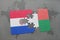 puzzle with the national flag of paraguay and madagascar on a world map