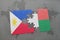 puzzle with the national flag of philippines and madagascar on a world map