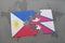 puzzle with the national flag of philippines and nepal on a world map background.