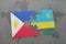 puzzle with the national flag of philippines and rwanda on a world map