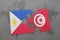 puzzle with the national flag of philippines and tunisia on a world map