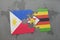 puzzle with the national flag of philippines and zimbabwe on a world map