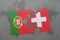 Puzzle with the national flag of portugal and switzerland on a world map background.