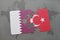 puzzle with the national flag of qatar and turkey on a world map background.