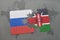 puzzle with the national flag of russia and kenya on a world map background.